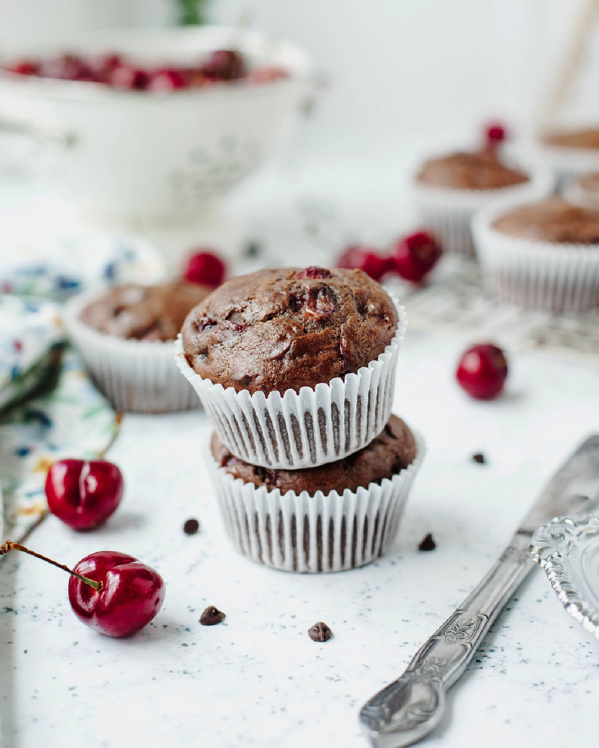 Stacked chocolate cherry muffins ready to serve.