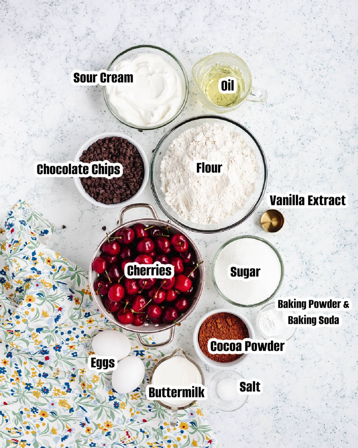 All the ingredients needed to make chocolate cherry muffins.