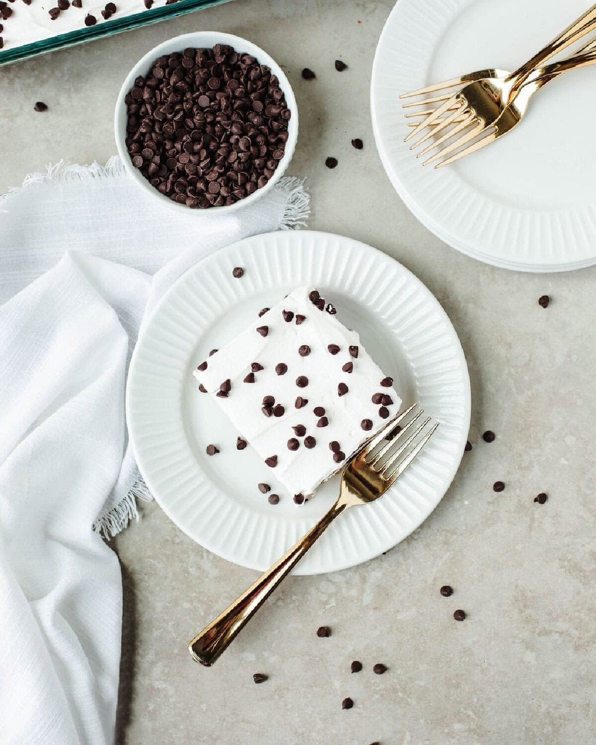 A served piece of chocolate chip pudding cake with a fork.