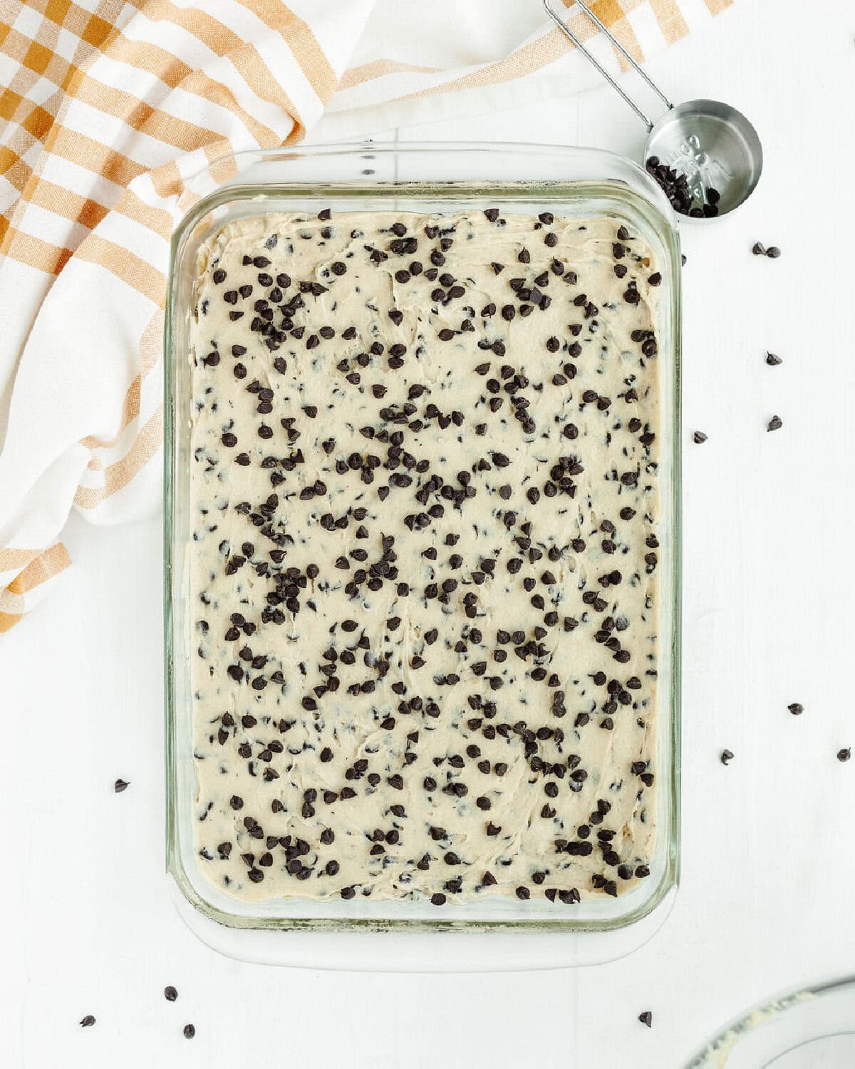 Chunky monkey brownie batter spread evenly into a prepared 9x13 baking dish.