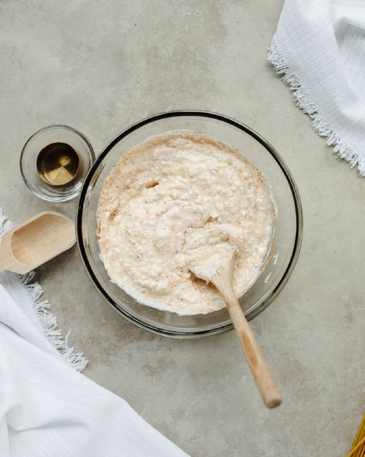 Mayonnaise, Parmesan, salt, garlic, and pepper combined in a glass bowl.