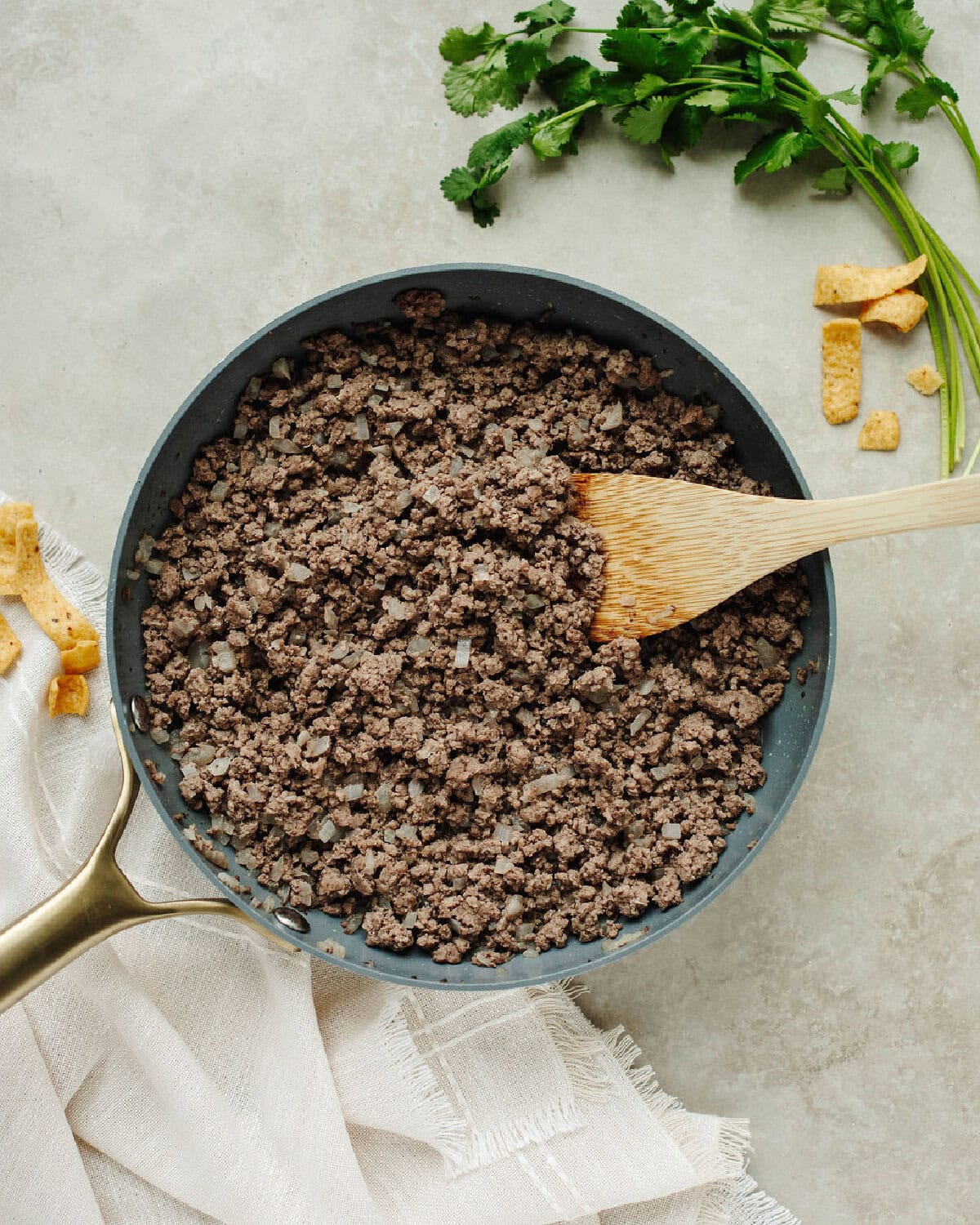 Ground beef browned with onions in a skillet.