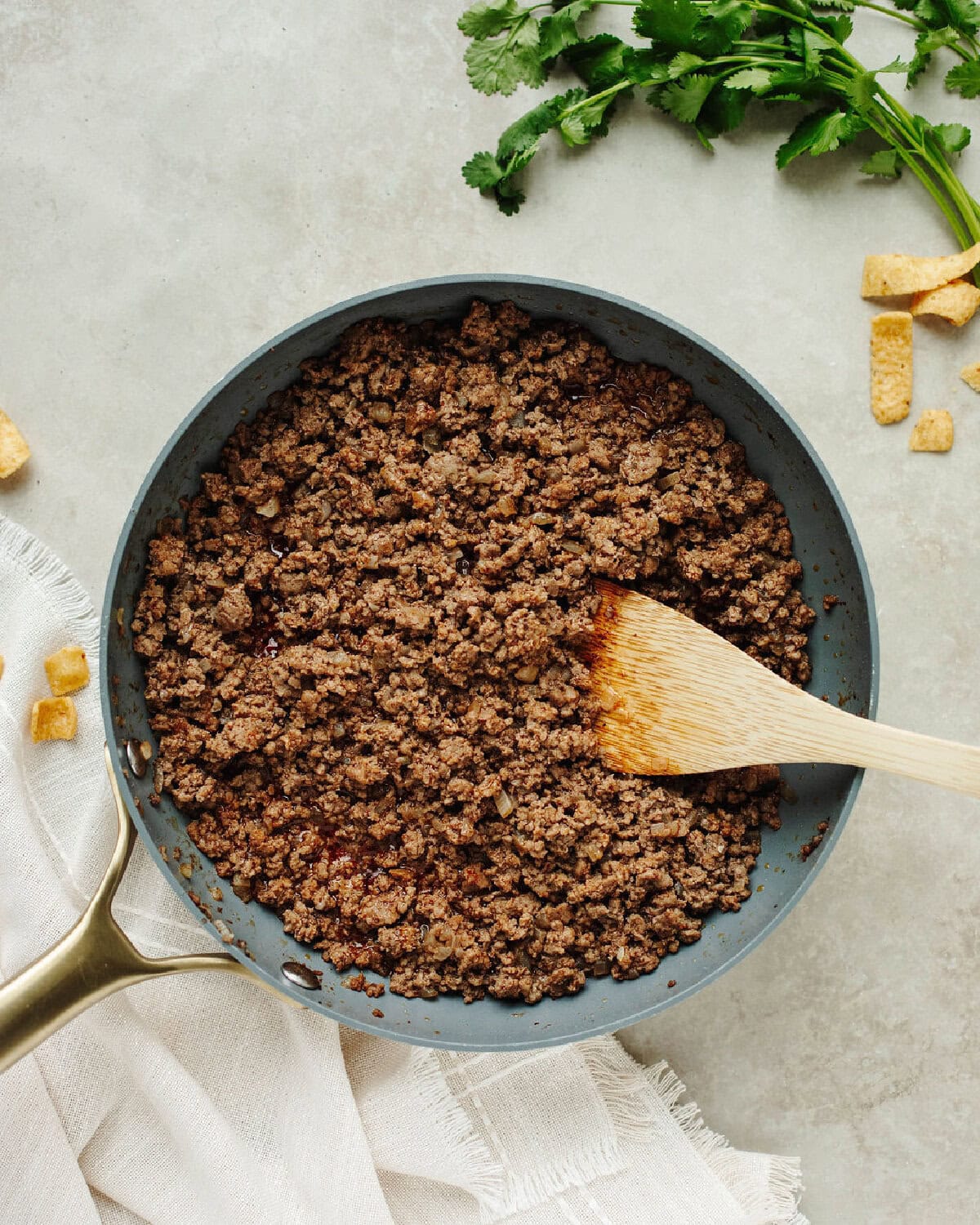 Browned ground beef seasoned with taco seasoning in a skillet.