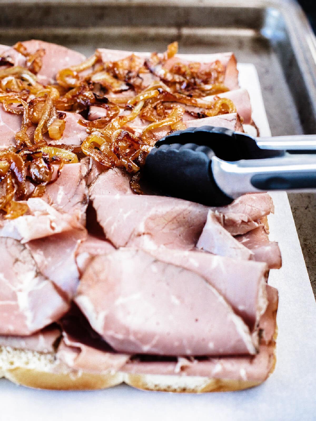 Sauteed onions placed on top of deli sliced roast beef.