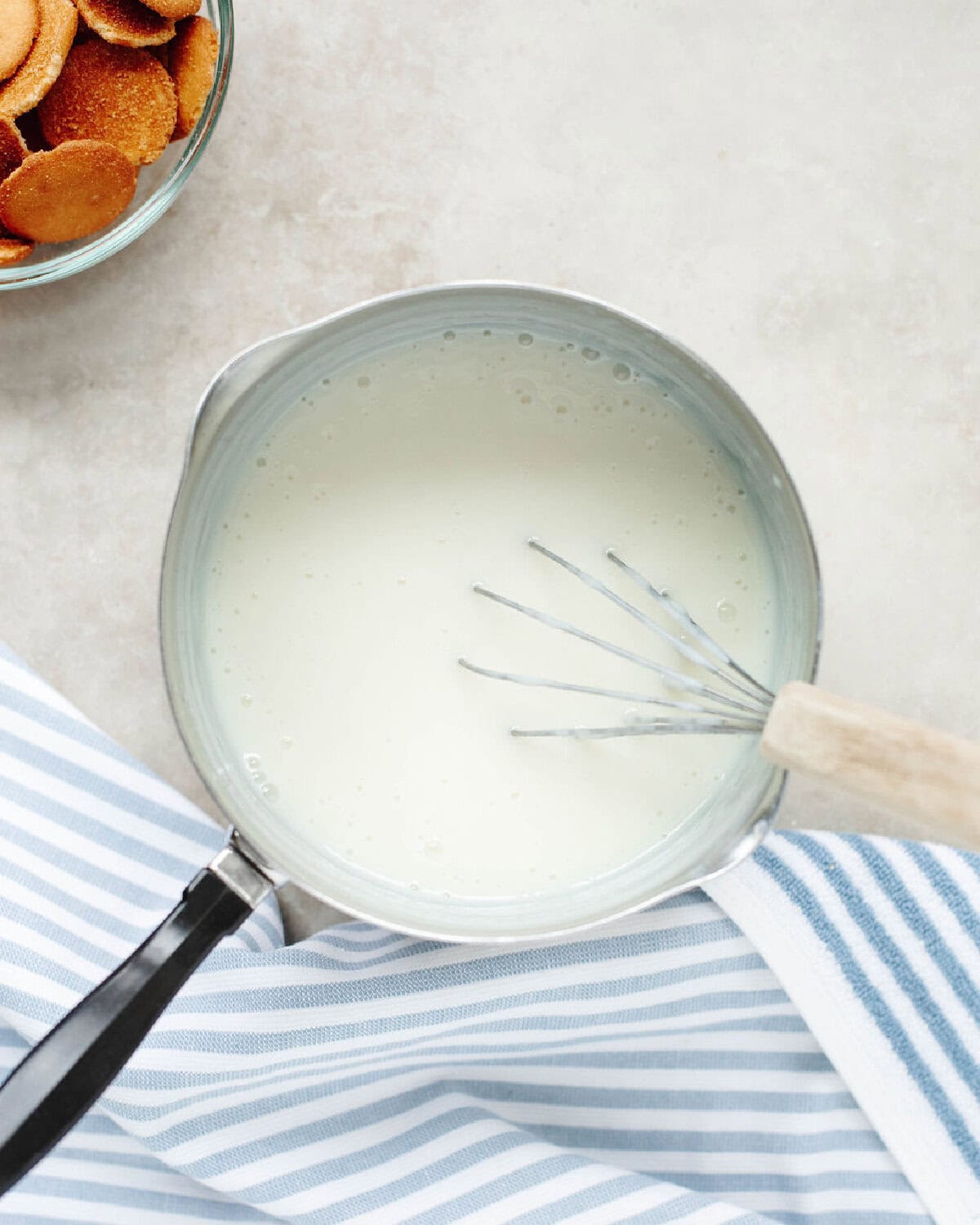 Sugar, flour, salt, and milk whisked together in a saucepan.