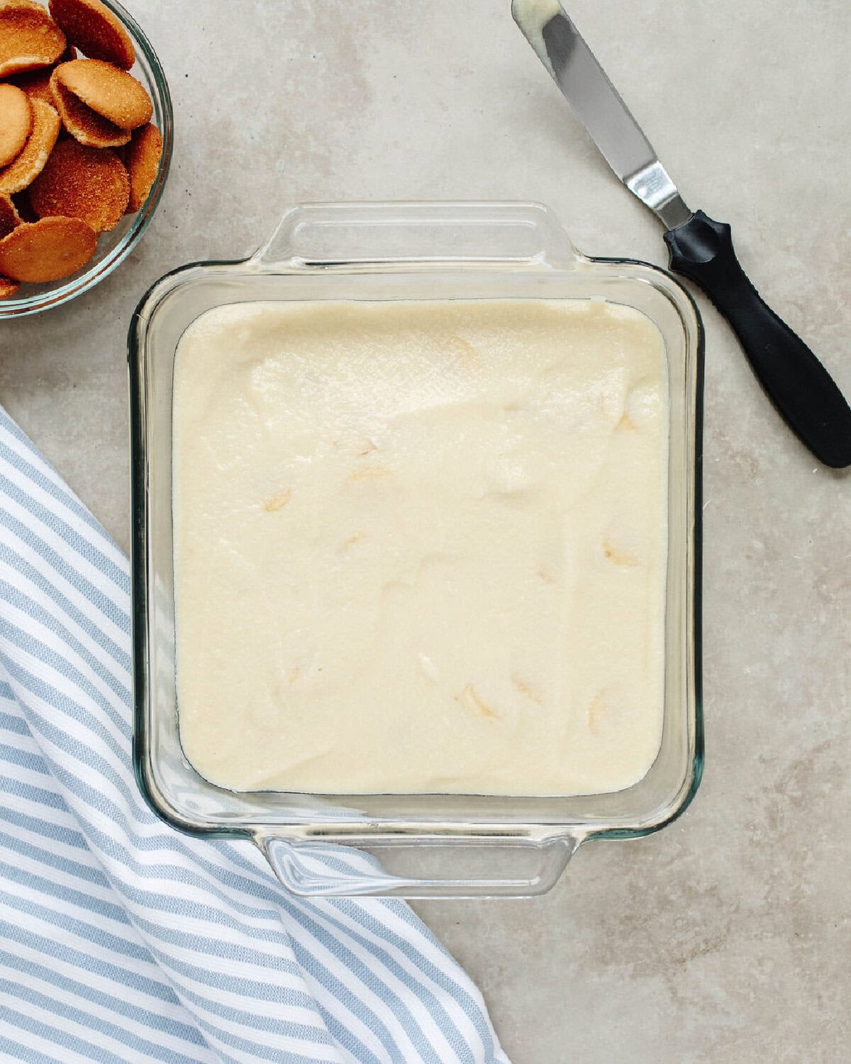 Homemade vanilla pudding spread over the banana slices and vanilla wafers.