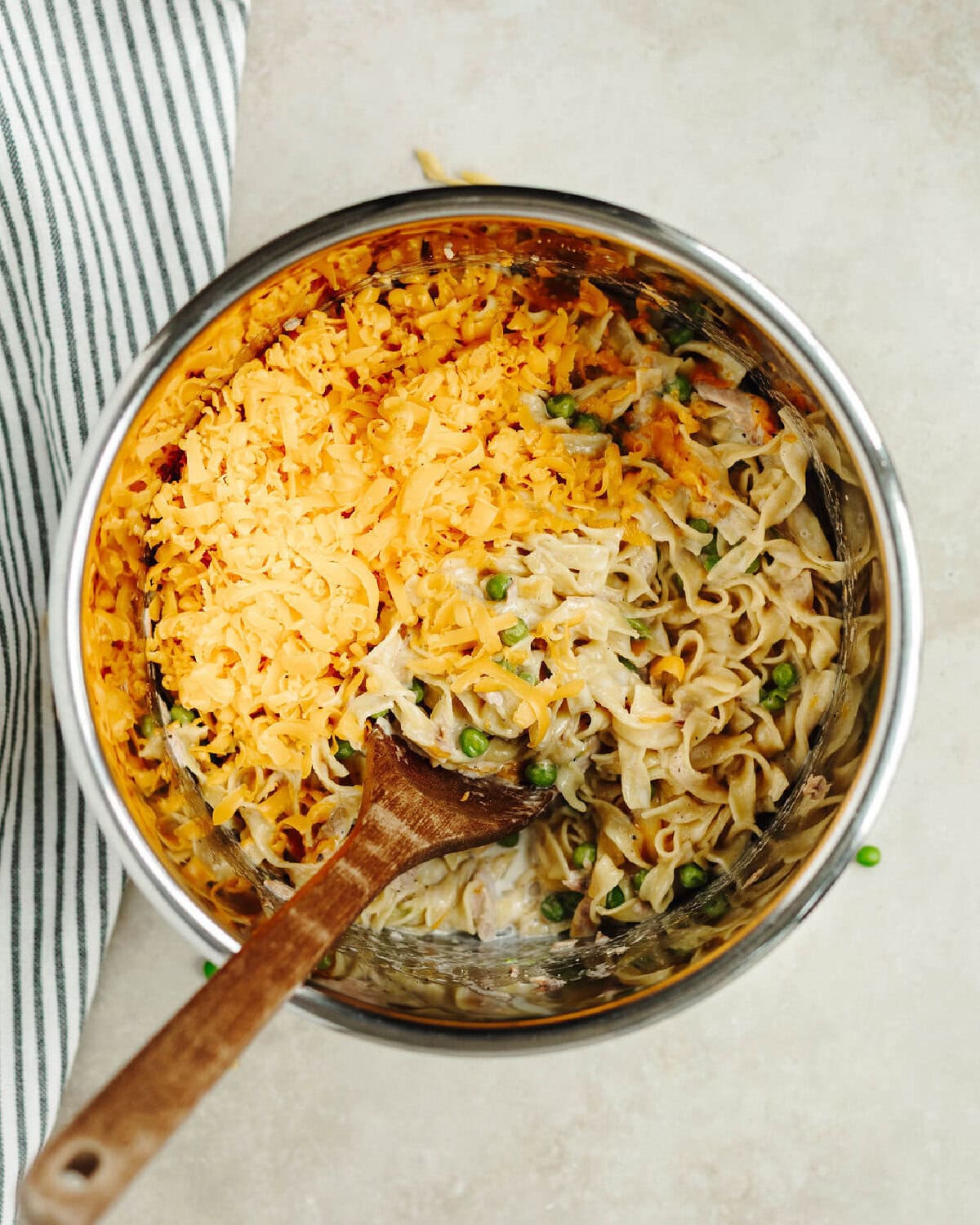 Shredded Cheddar cheese added on tuna casserole.