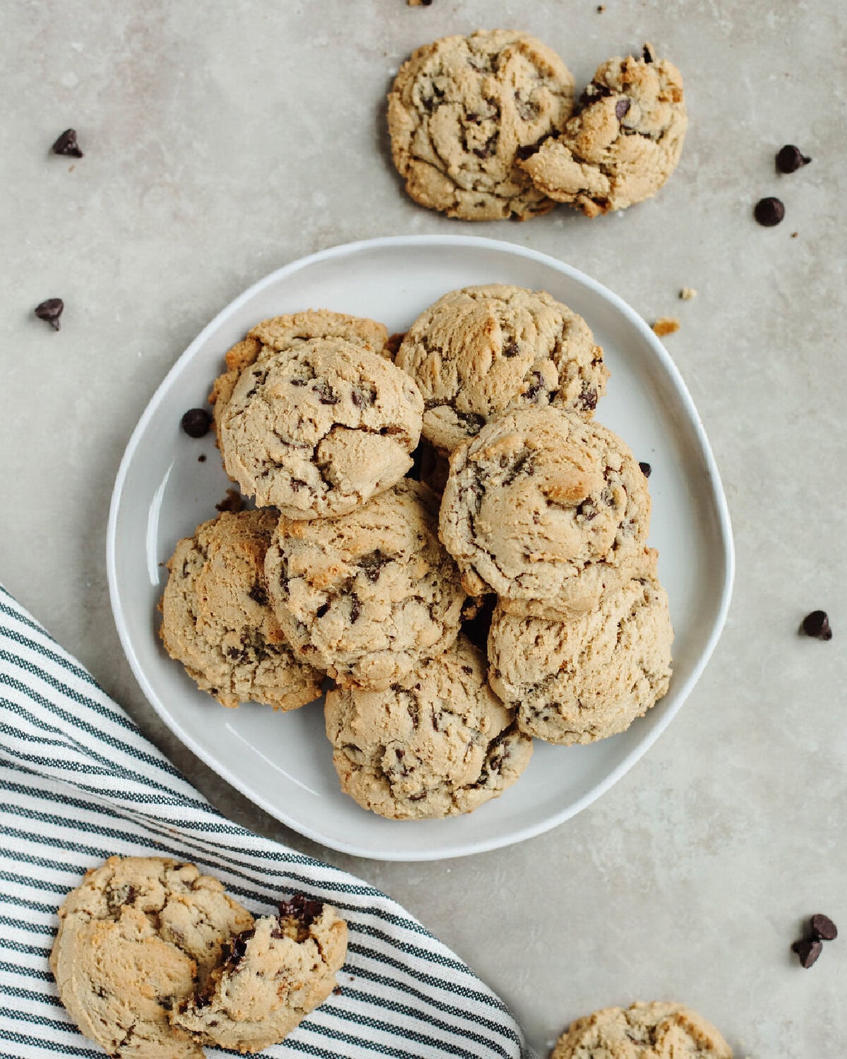 A white plate with a stack of baked Joanna Gaines chocolate chip cookies.