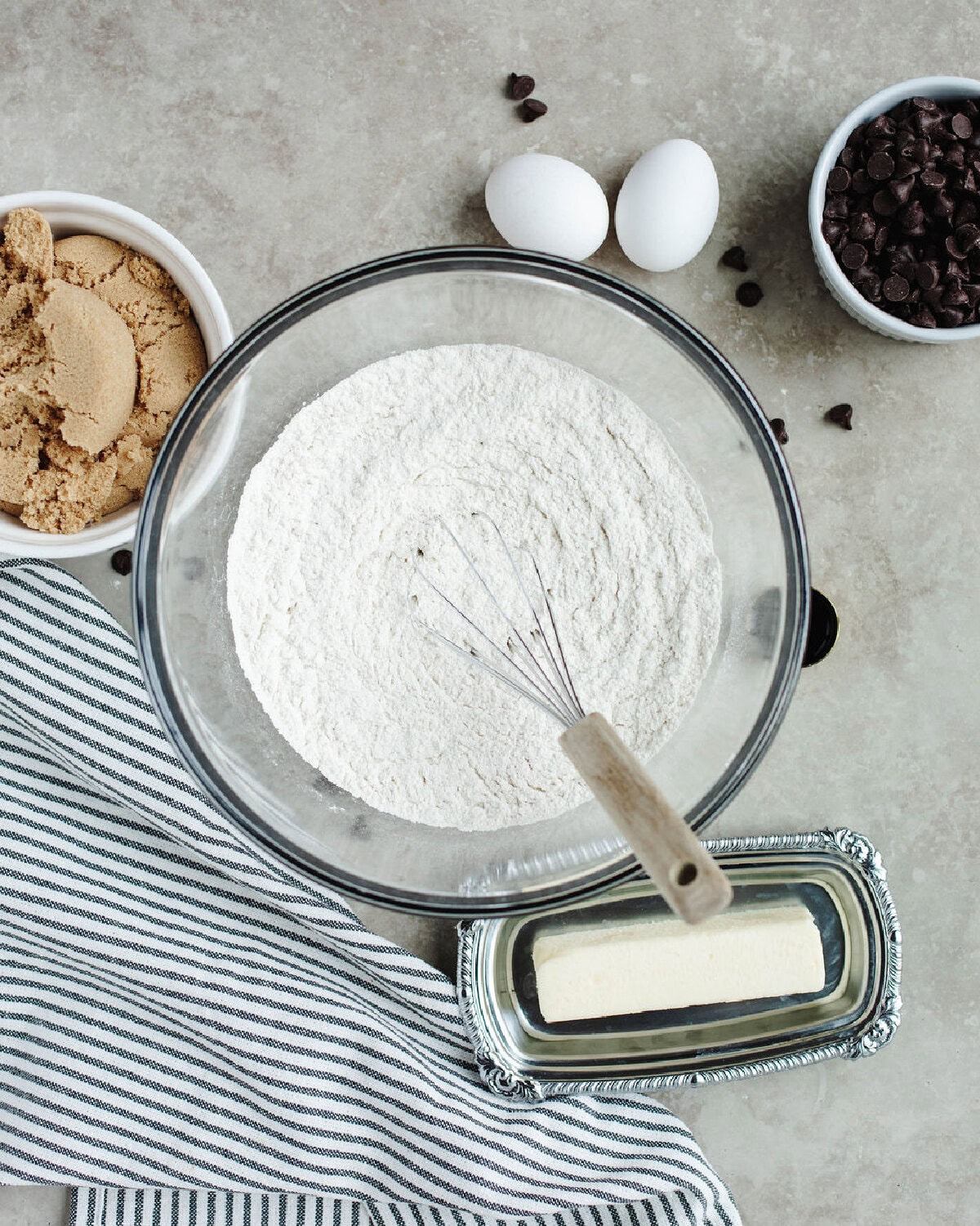 Flour, baking soda, and salt whisked together in a glass mixing bowl.