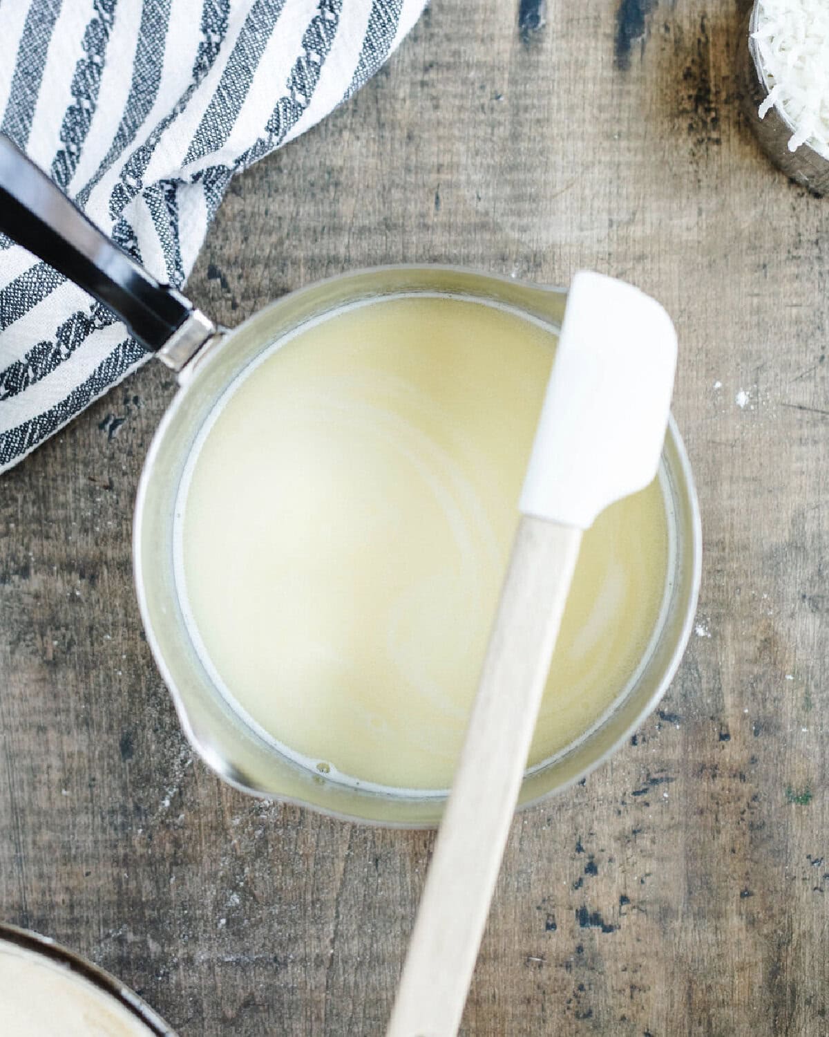 Heated milk combined with melted butter in a saucepan.
