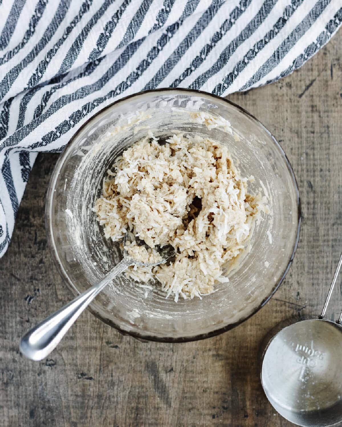 Flaky golden coconut topping made in a glass mixing bowl.