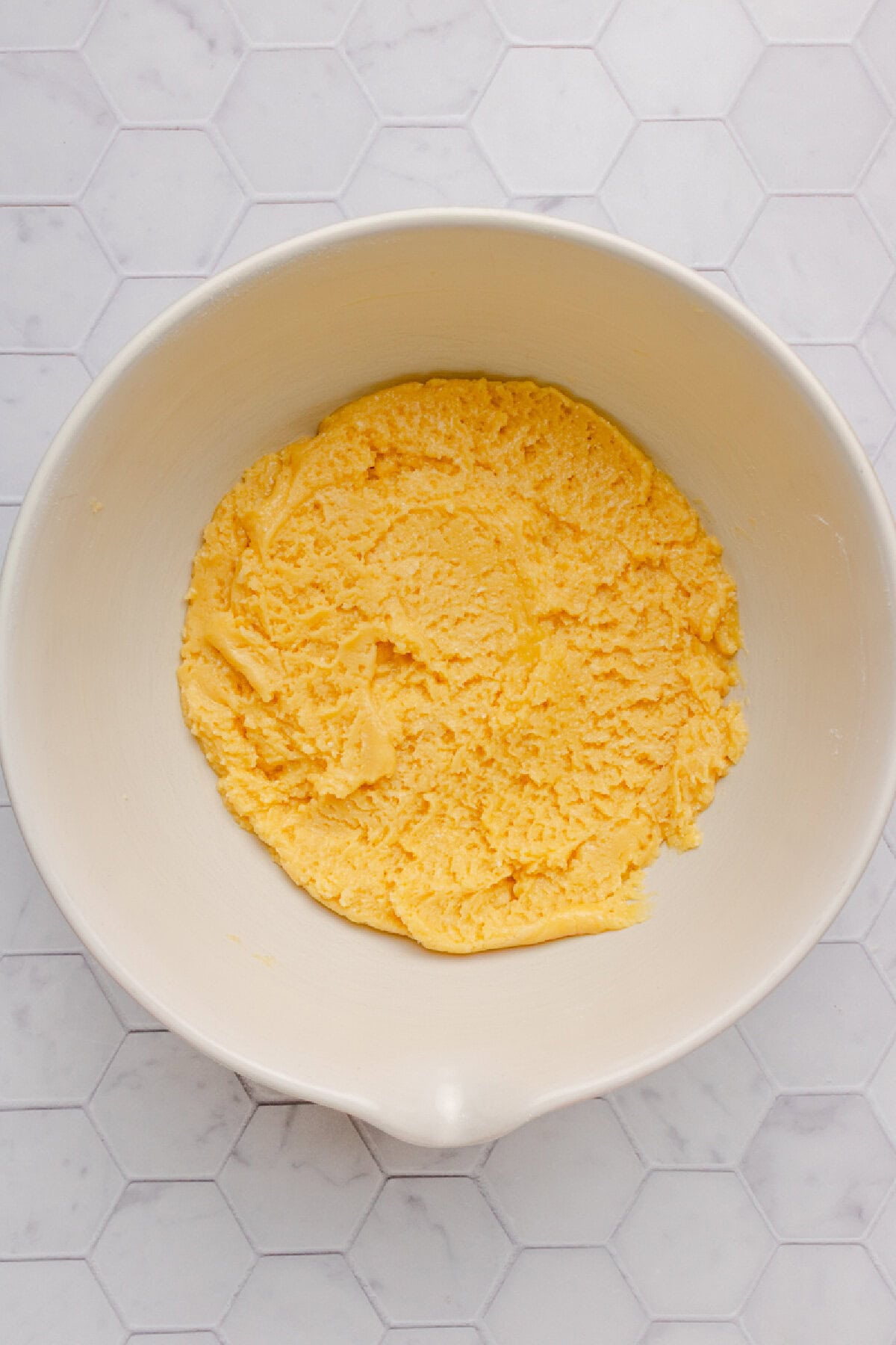 Cake mixture combined in a mixing bowl.