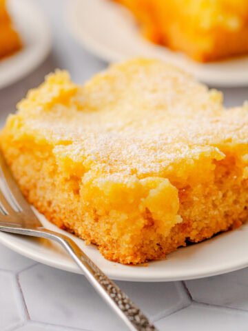 A slice of butter cake served on a white plate with a fork.