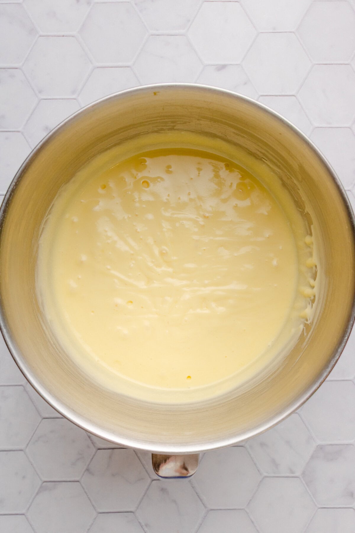 Eggs, vanilla, and butter combined in a mixing bowl.