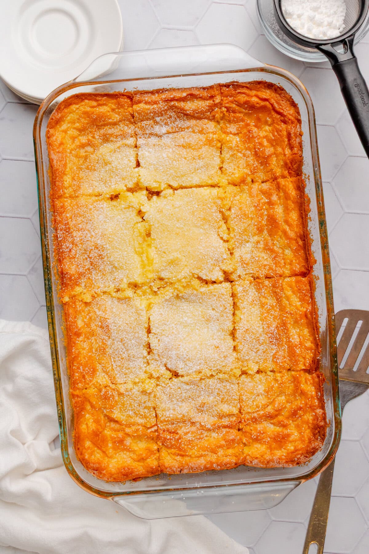 Baked butter cake ready to serve with a spatula.