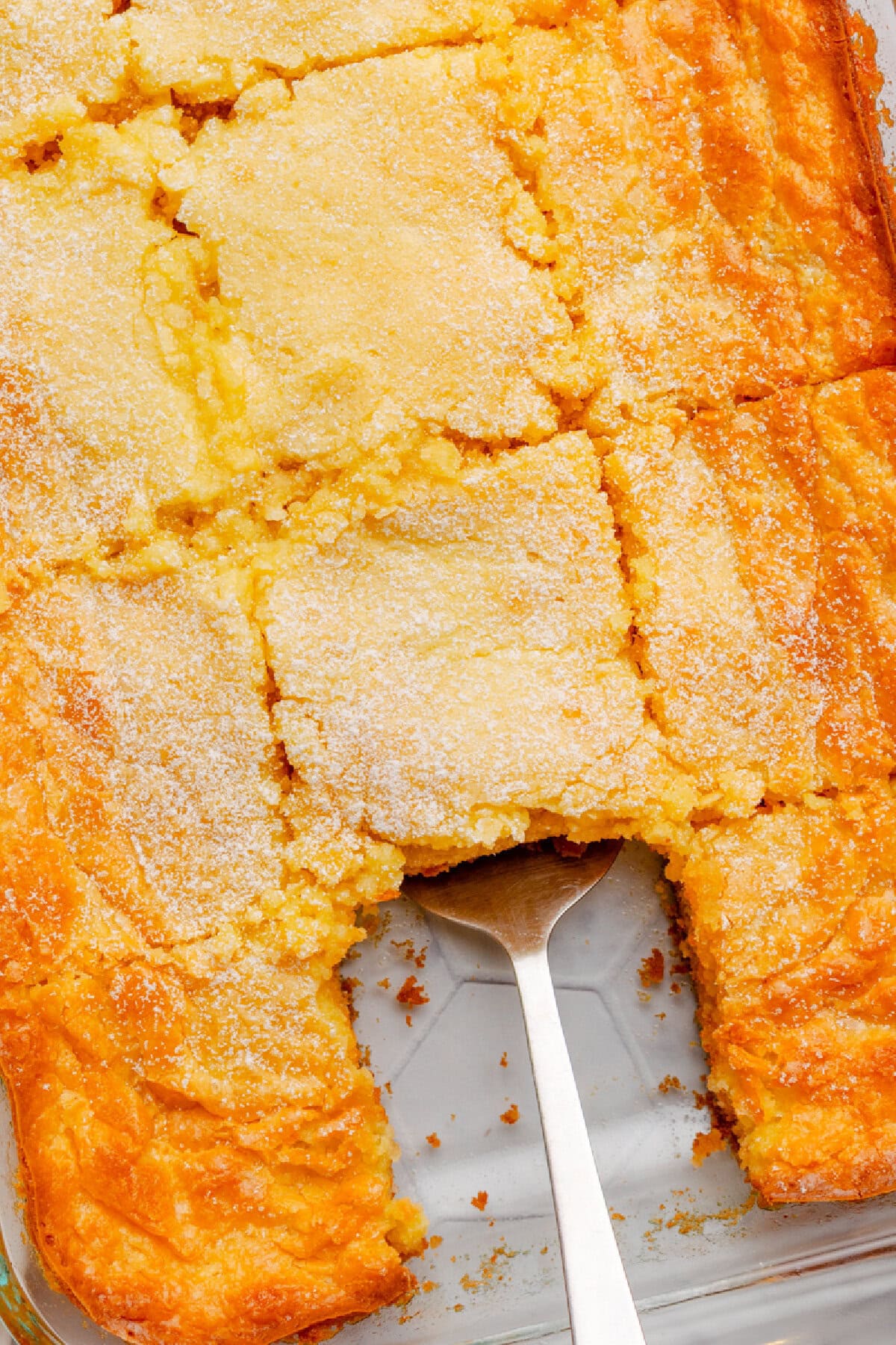 Baked butter cake scooped from a baking pan.