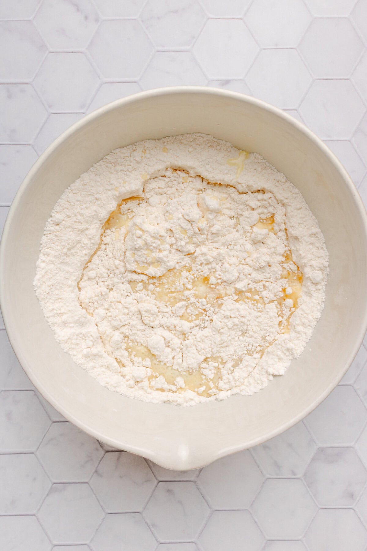 Cake mix, egg, and melted butter combined in a mixing bowl.