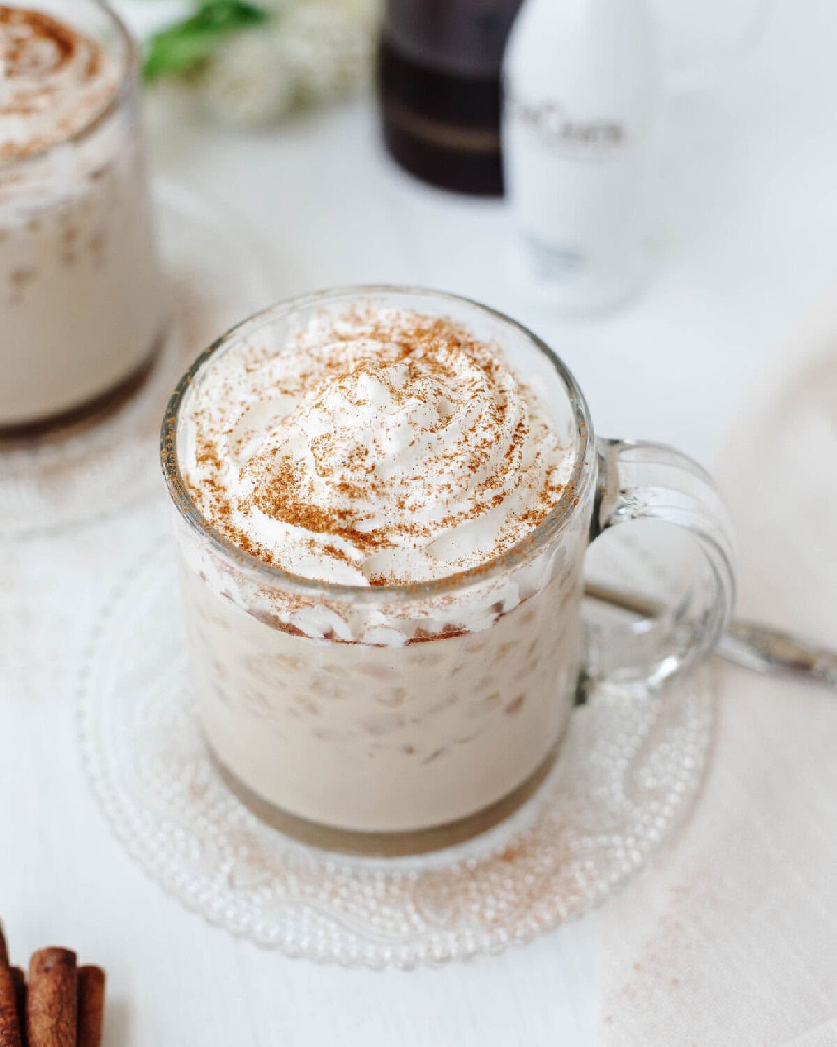 RumChata iced coffee in a glass mug topped with whipped cream and cinnamon.