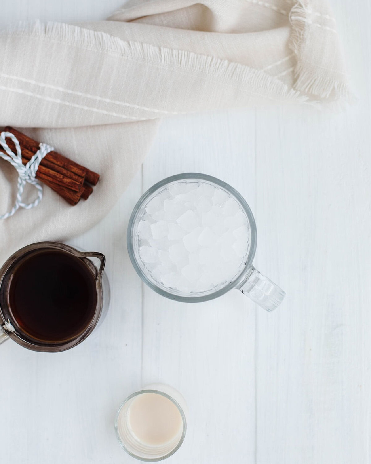 A glass mug filled with ice cubes.