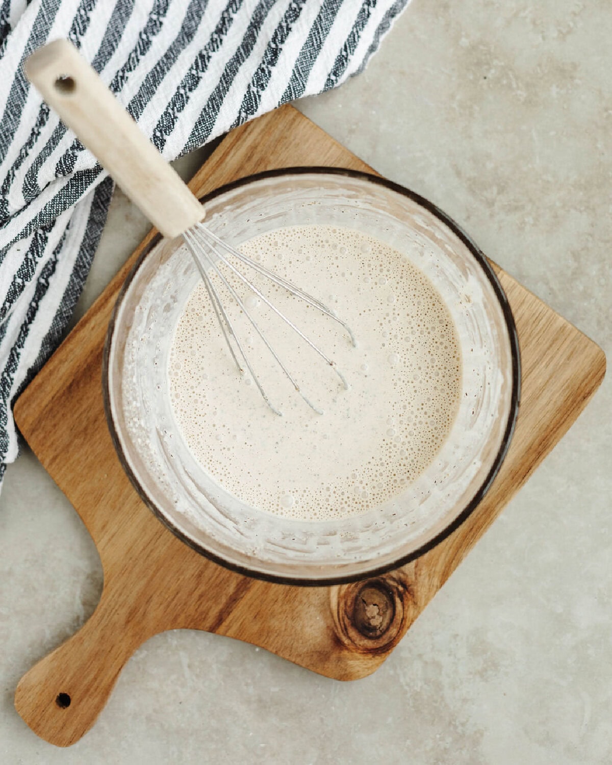 A homemade sauce whisked together in a glass bowl.