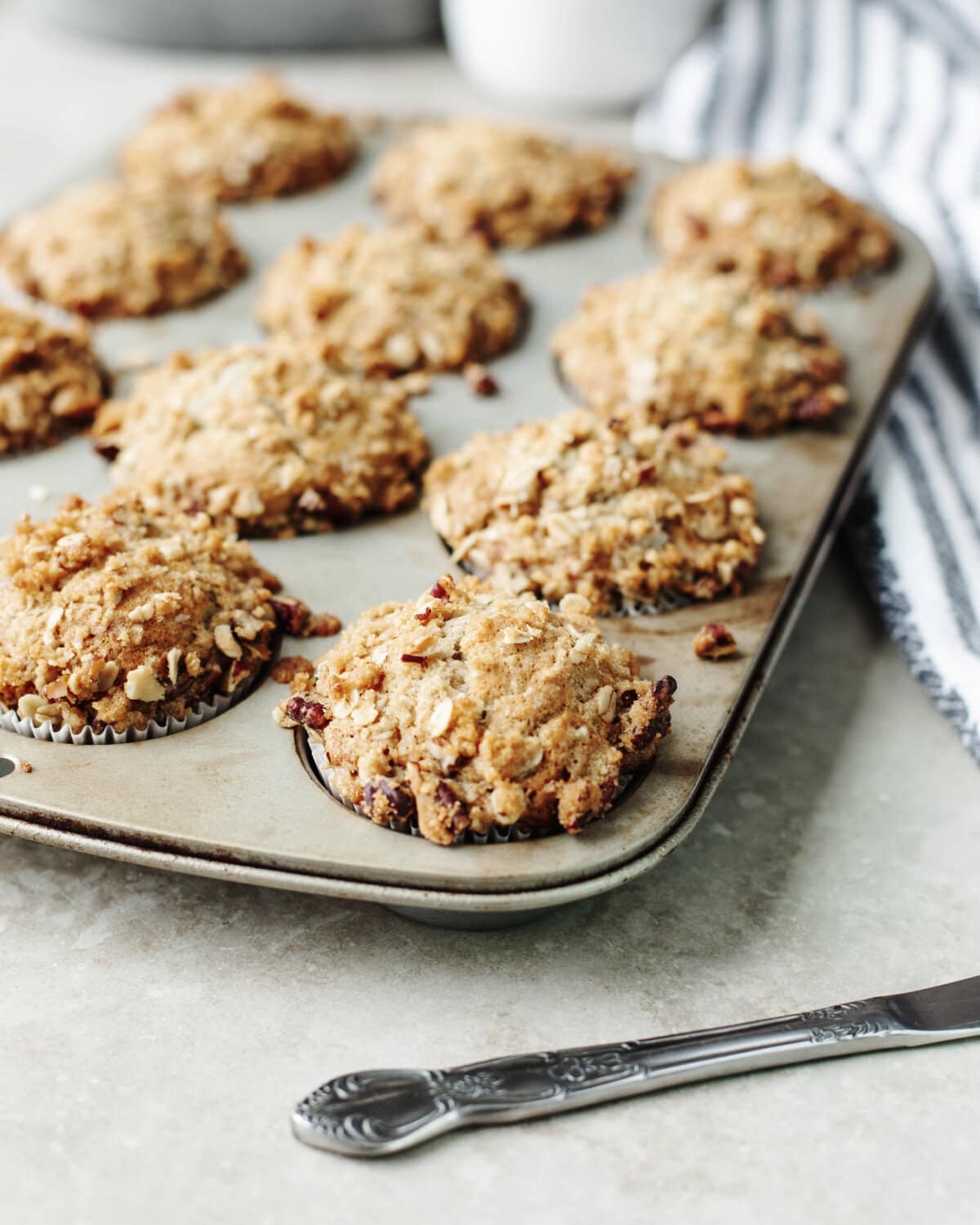 Baked banana pecan muffins in a muffin tray ready to serve.