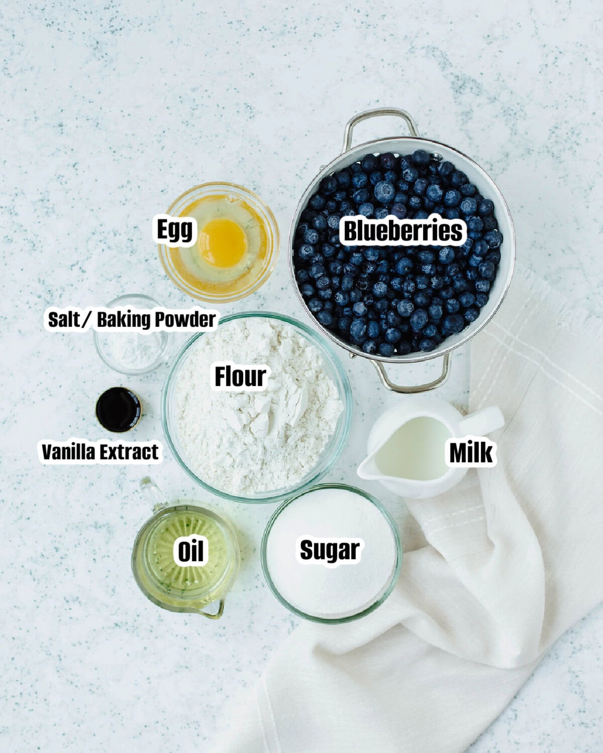 All the ingredients needed to make homemade blueberry muffins.