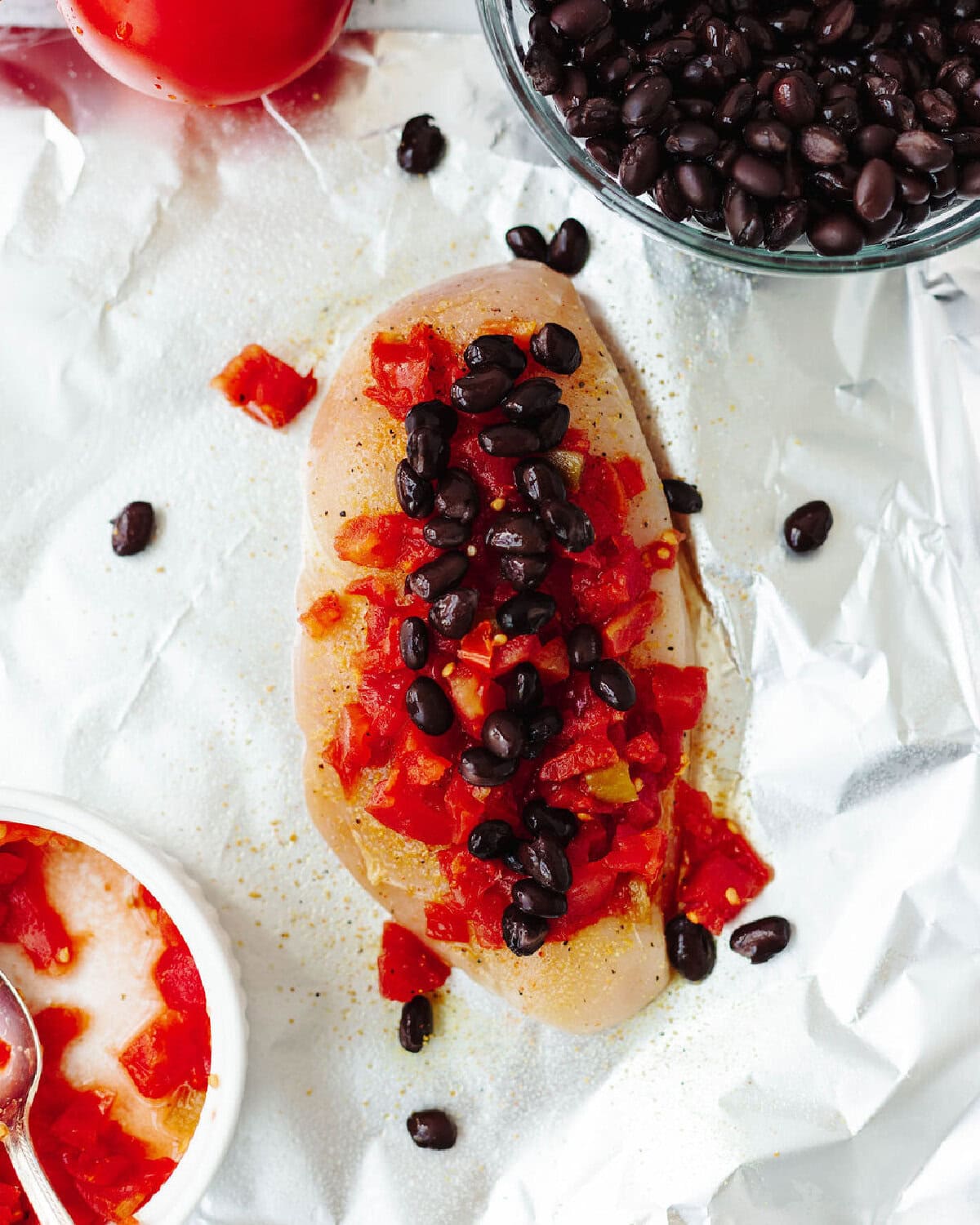 Black beans and Rotel on top of a seasoned boneless skinless chicken breast.