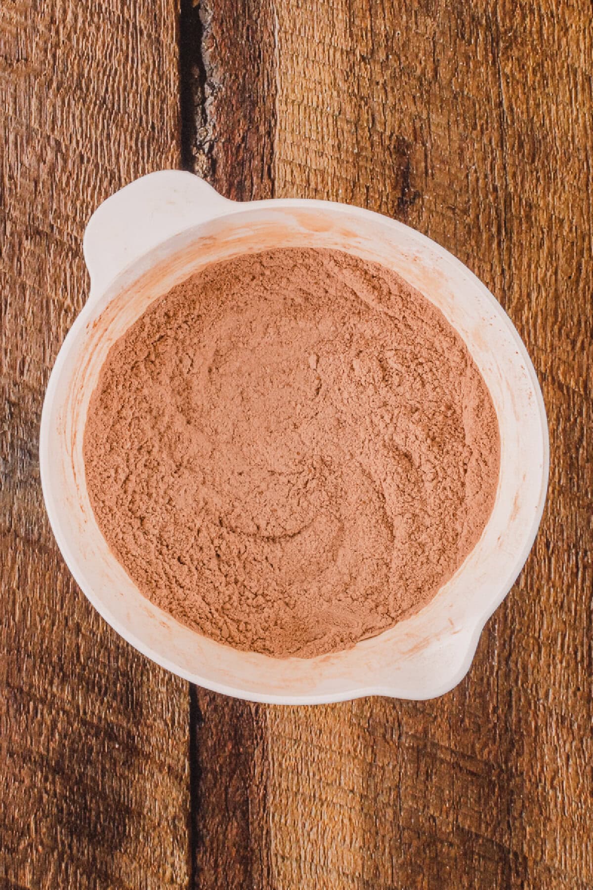 Flour, cocoa powder, salt, and baking soda whisked together in a mixing bowl.