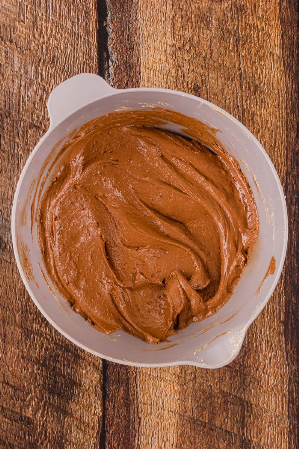 Cookie dough blended and ready for chocolate chips in a mixing bowl.