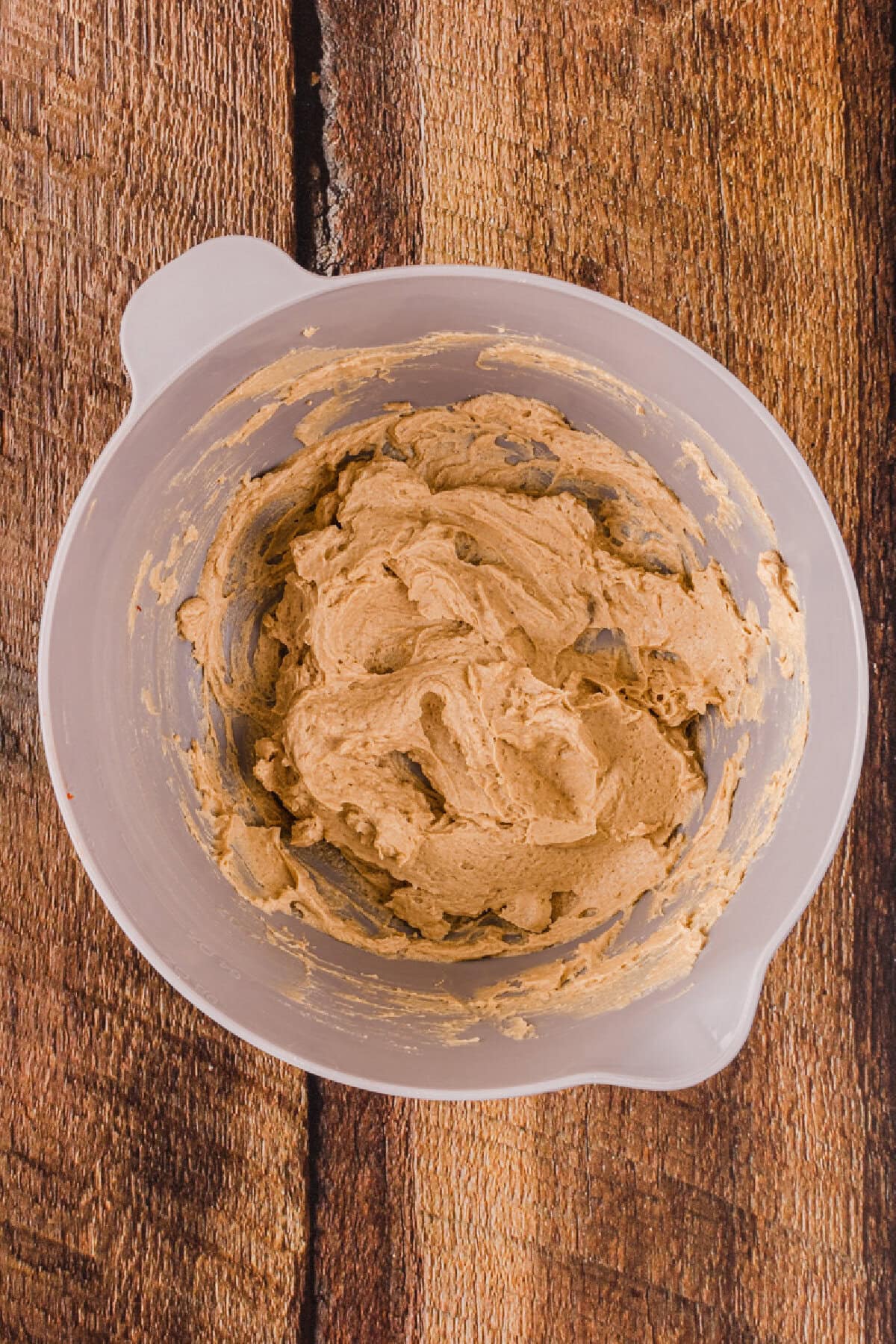 Butter and sugar creamed together in a mixing bowl.