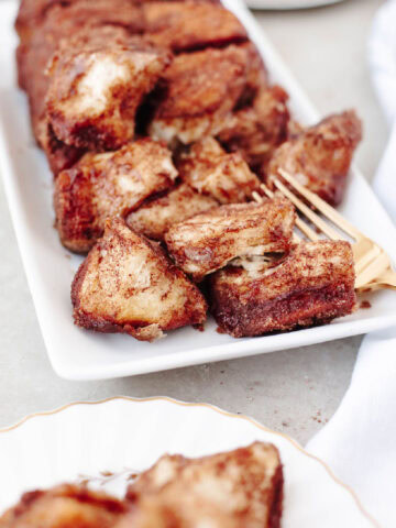 Cinnamon sugar pull apart bread on a white serving platter.