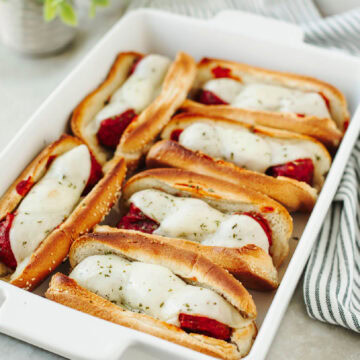 A white baking dish with easy meatball subs ready to enjoy.