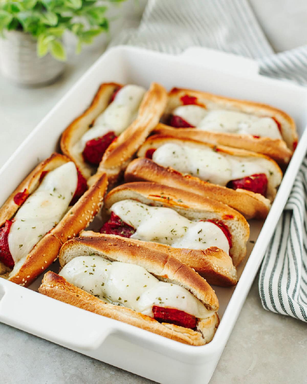 A white baking dish with easy meatball subs ready to enjoy.