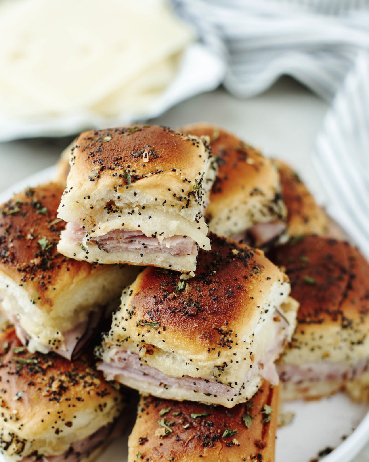 Stacked funeral sandwiches on a white plate ready to serve.