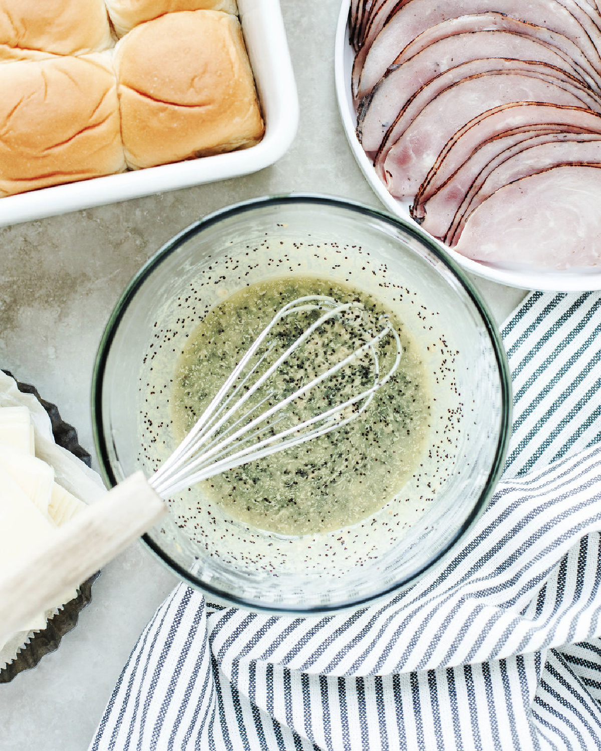 Melted butter, Dijon mustard, Worcestershire sauce, onion, and poppy seeds combined in a small bowl.