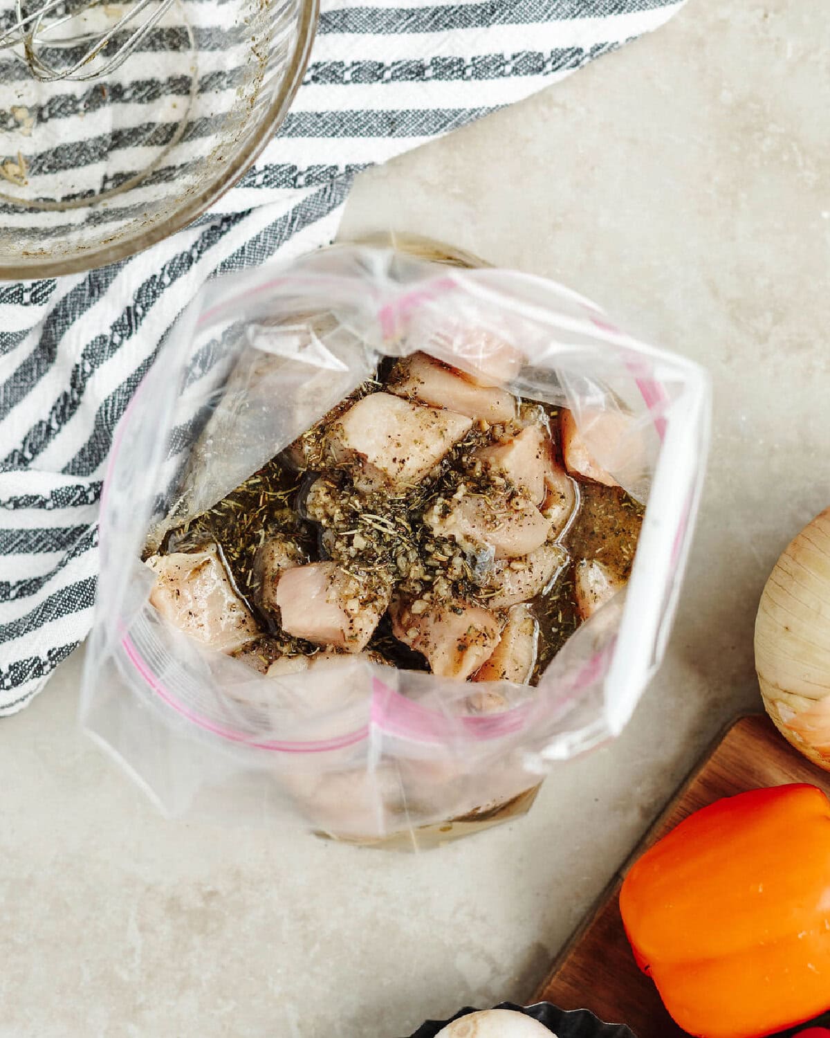 Diced chicken pieces in a Ziploc bag with homemade marinade.