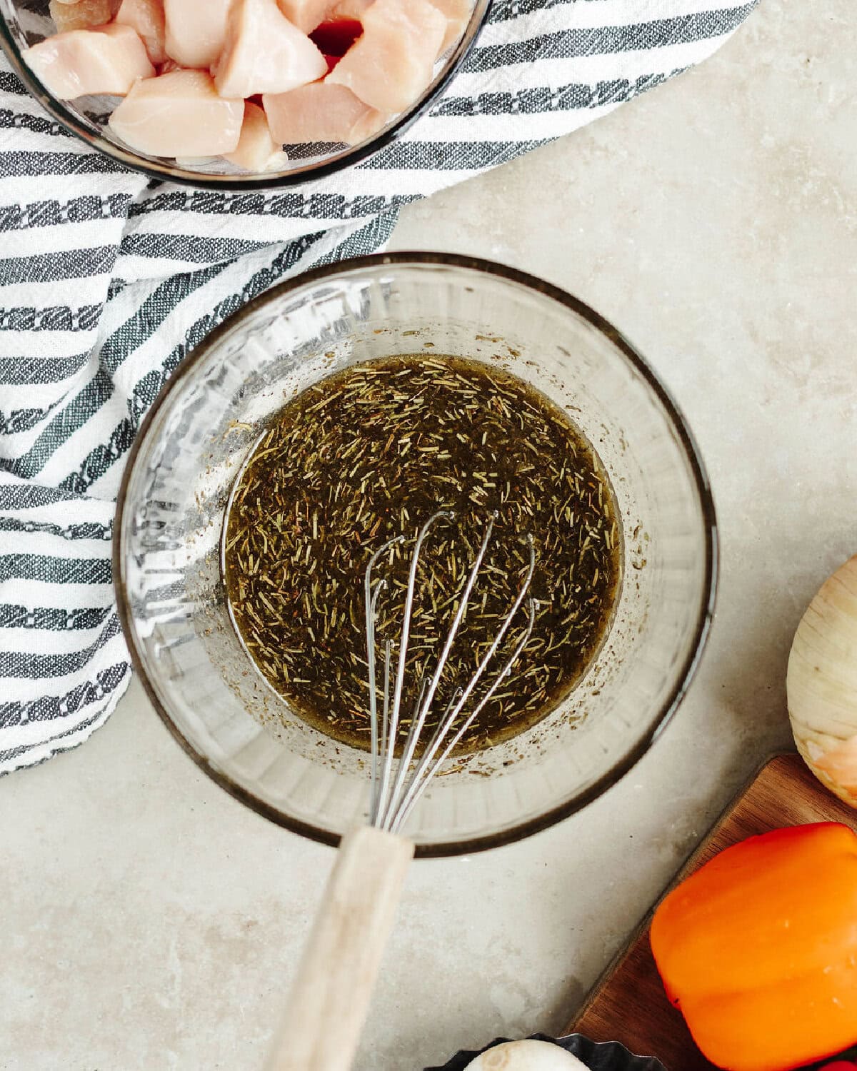 Homemade marinade whisked in a glass mixing bowl.