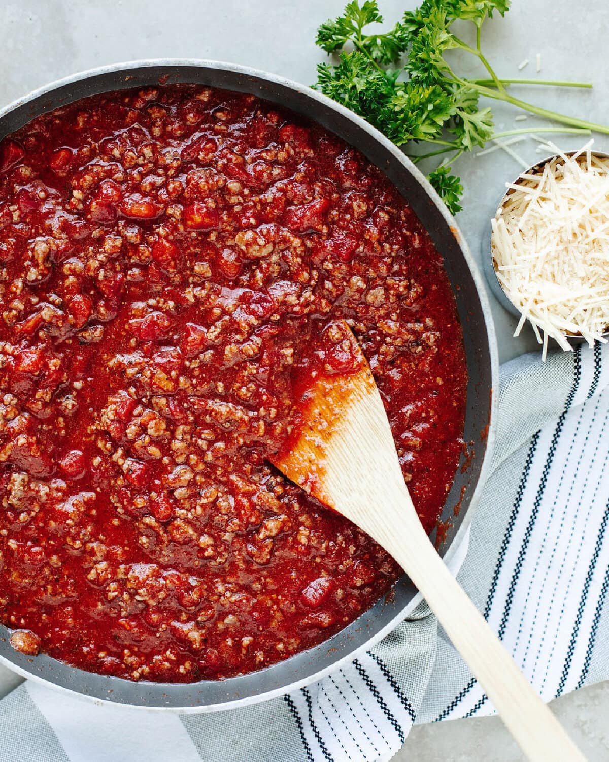 Seasoned ground beef and tomato sauce simmering in a skillet.