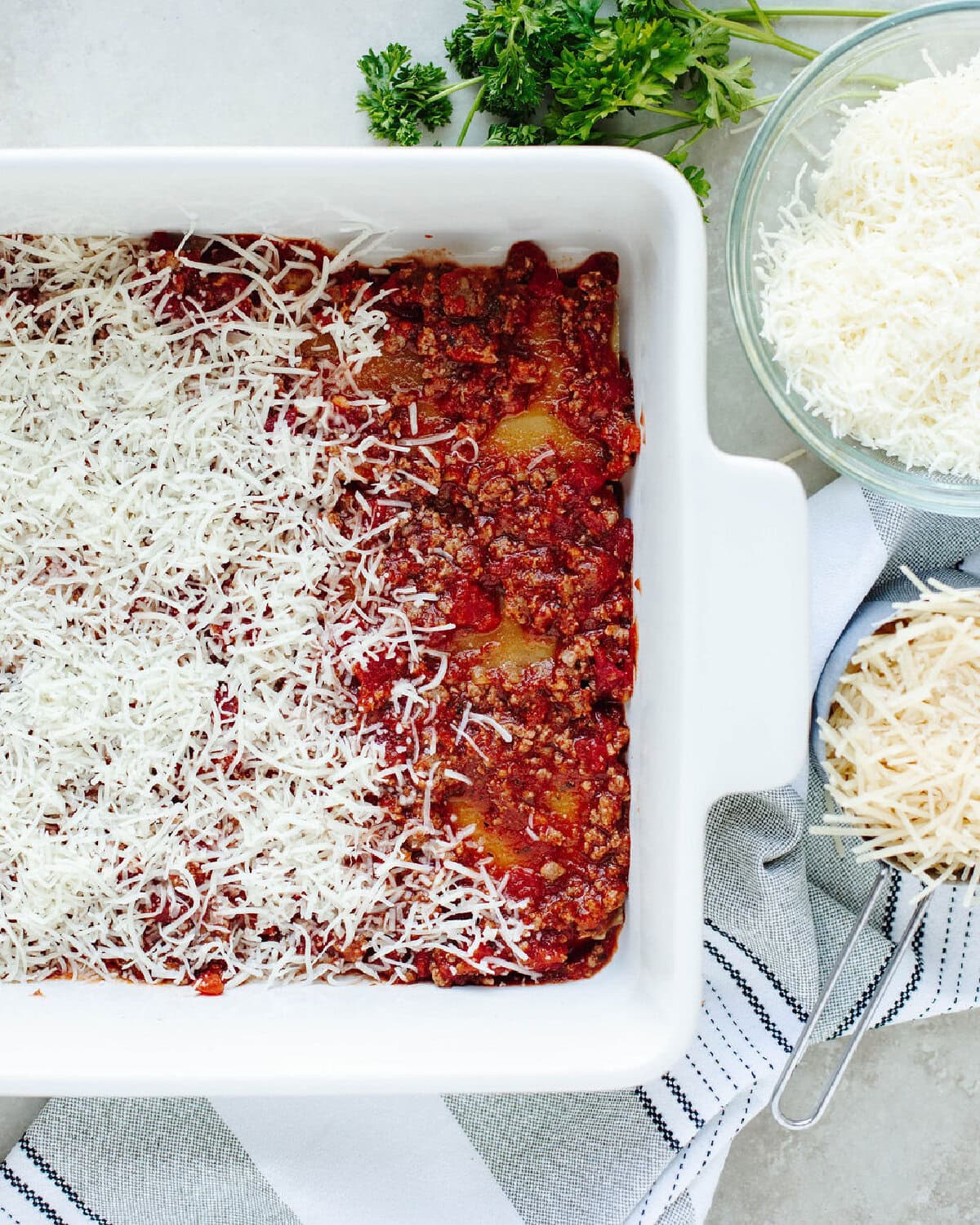 Layer of mozzarella cheese added over rich meat sauce.