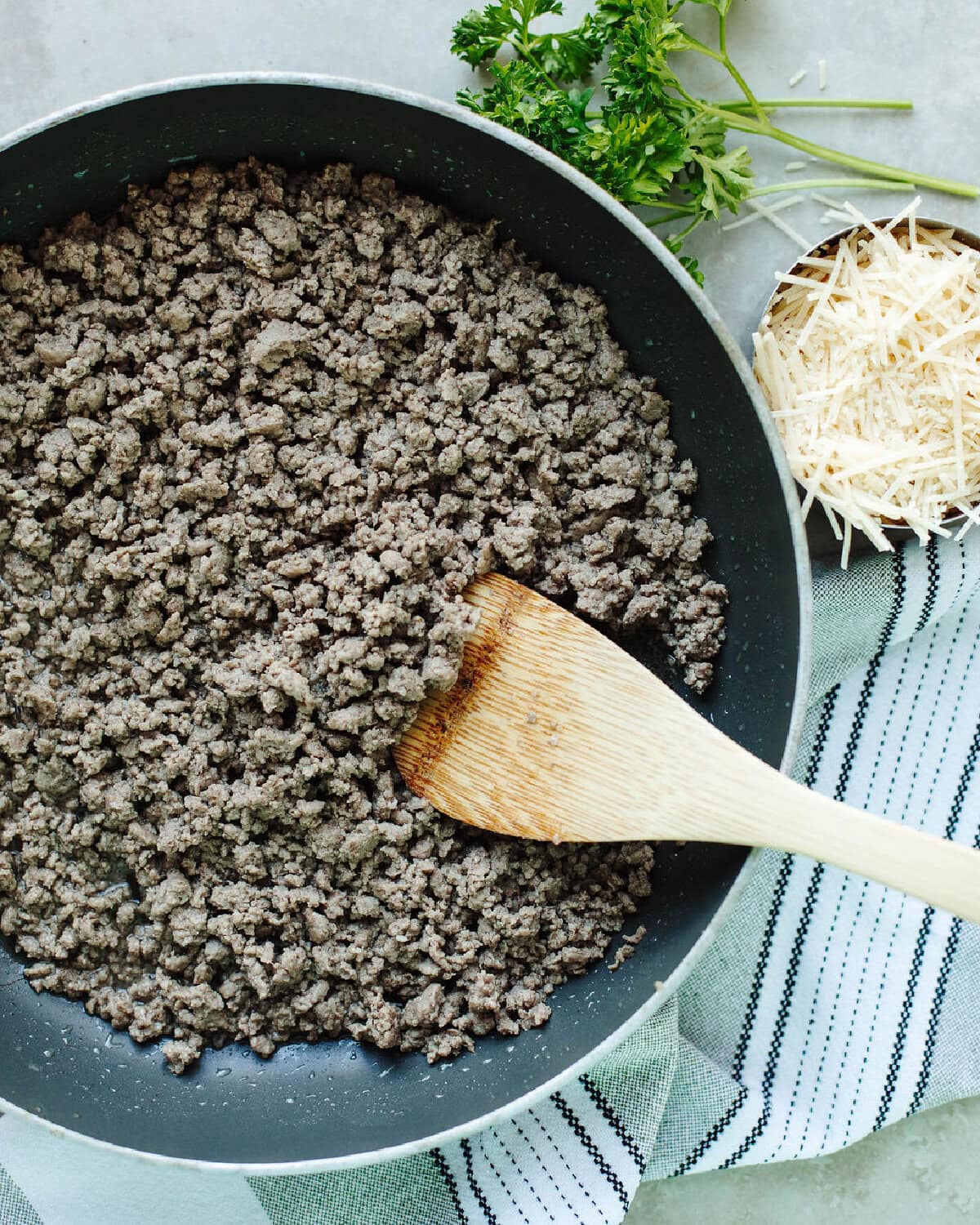 Cooked ground beef browned in a skillet.