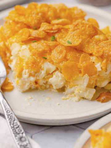 Hash Brown Potato Bake served on a white plate with a fork.