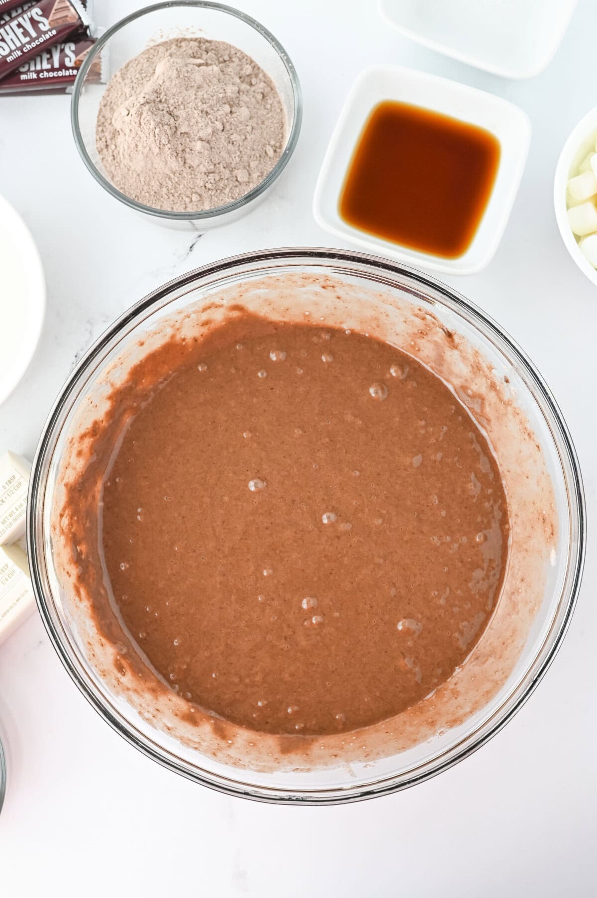 Chocolate cake mix prepared in a glass mixing bowl.