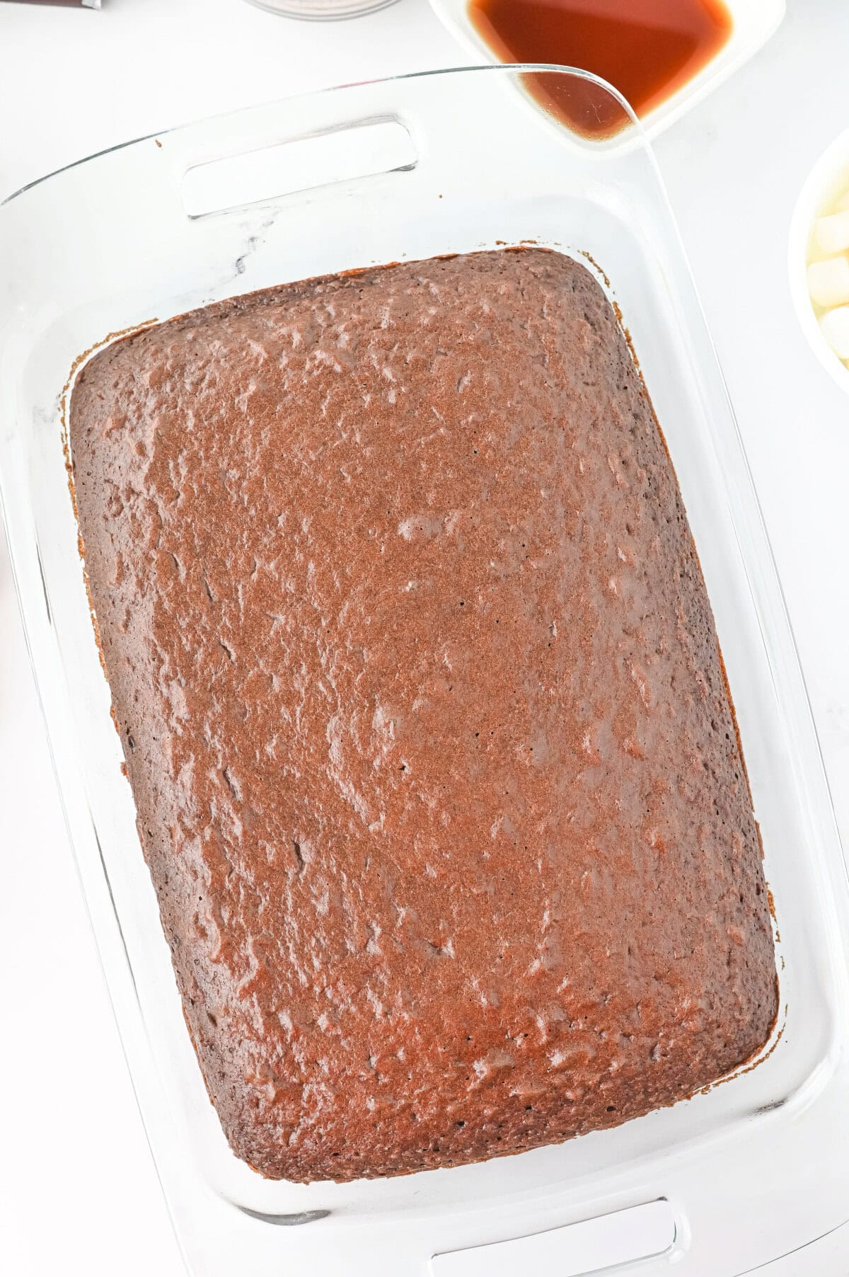 A baked chocolate cake in a prepared 9x13 baking dish.