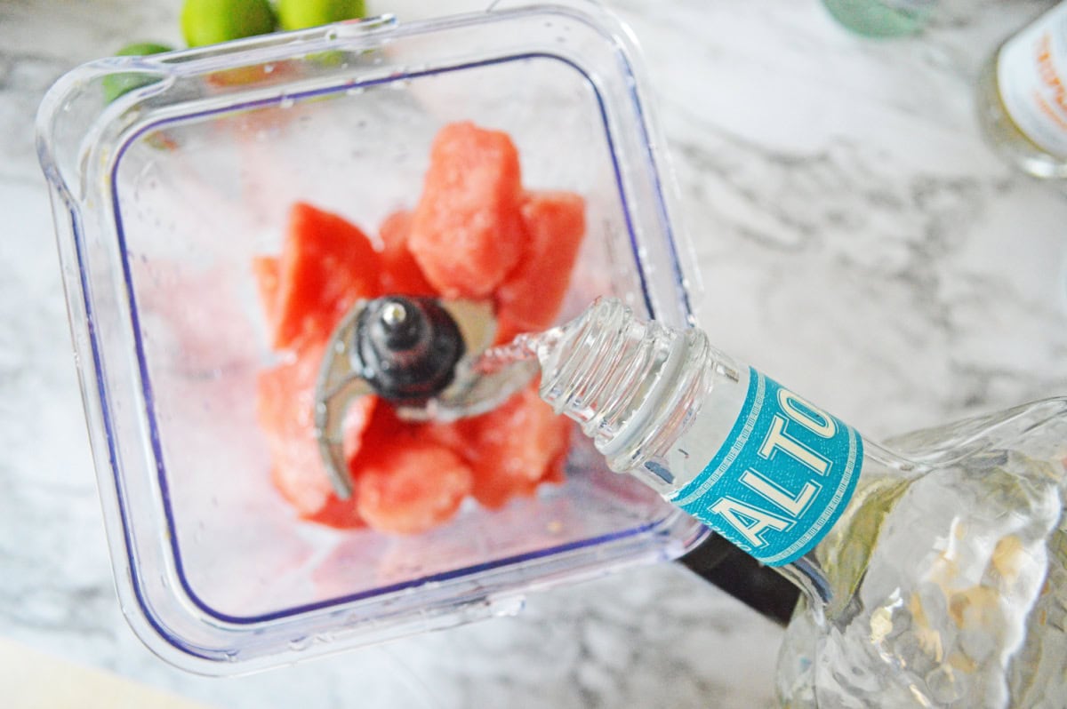Tequila added to a blender pitcher.