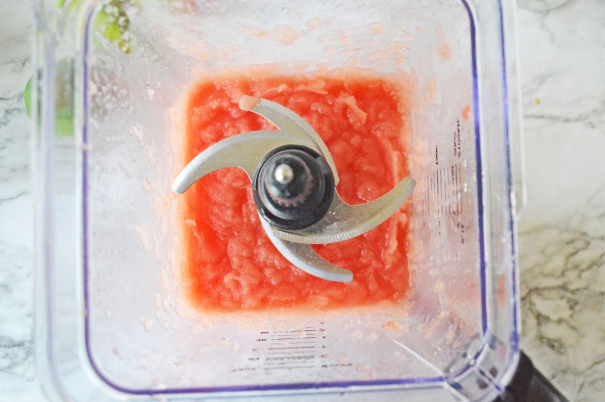 A blender mixing together ingredients for a drink.