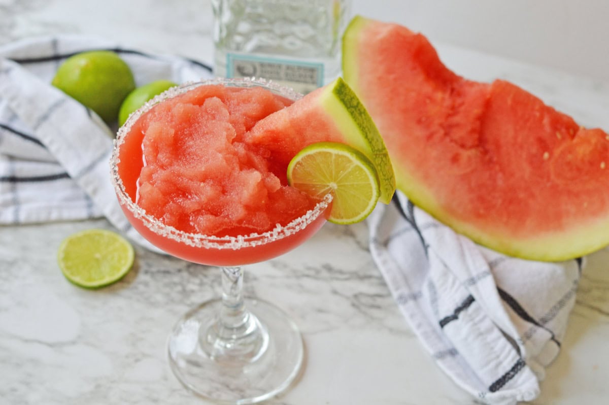 A top view of a frozen watermelon margarita in a salt rimmed glass.