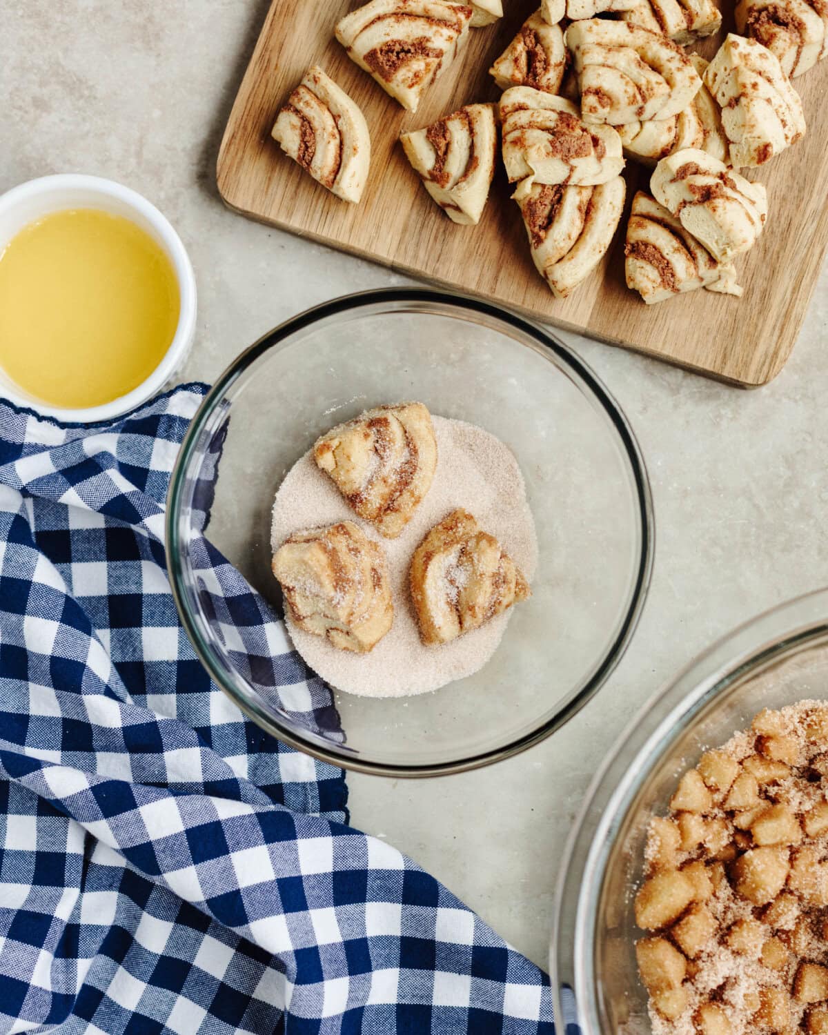 Cinnamon roll pieces rolled in cinnamon and sugar in a glass dish.