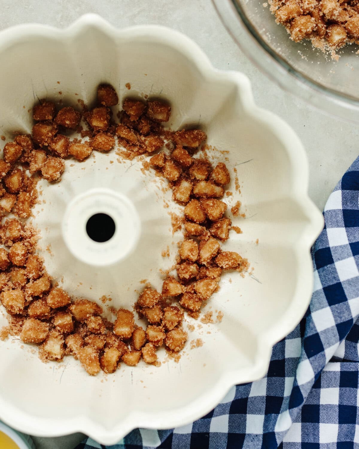 Diced apples covered in cinnamon sugar and placed on the bottom of a bundt pan.