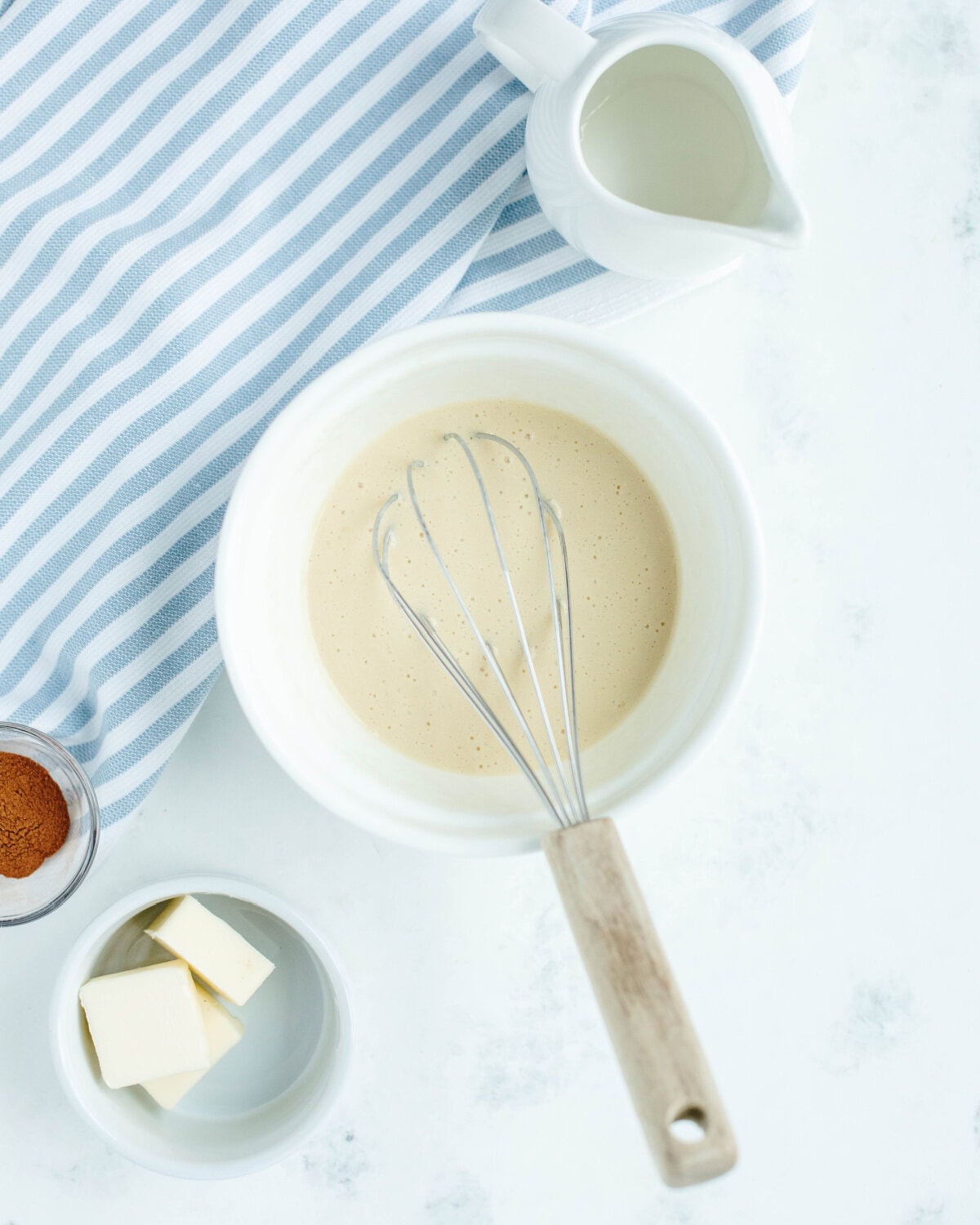 Buttermilk, egg, melted butter, and vanilla extract whisked together in a mixing bowl.