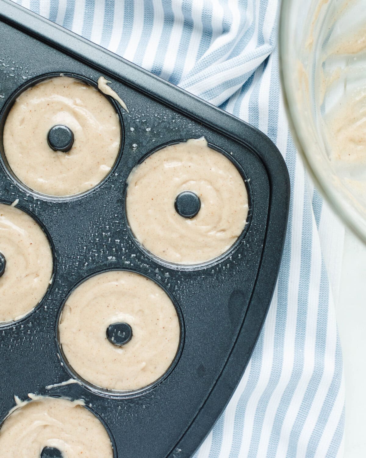 Batter poured into a prepared doughnut tray.